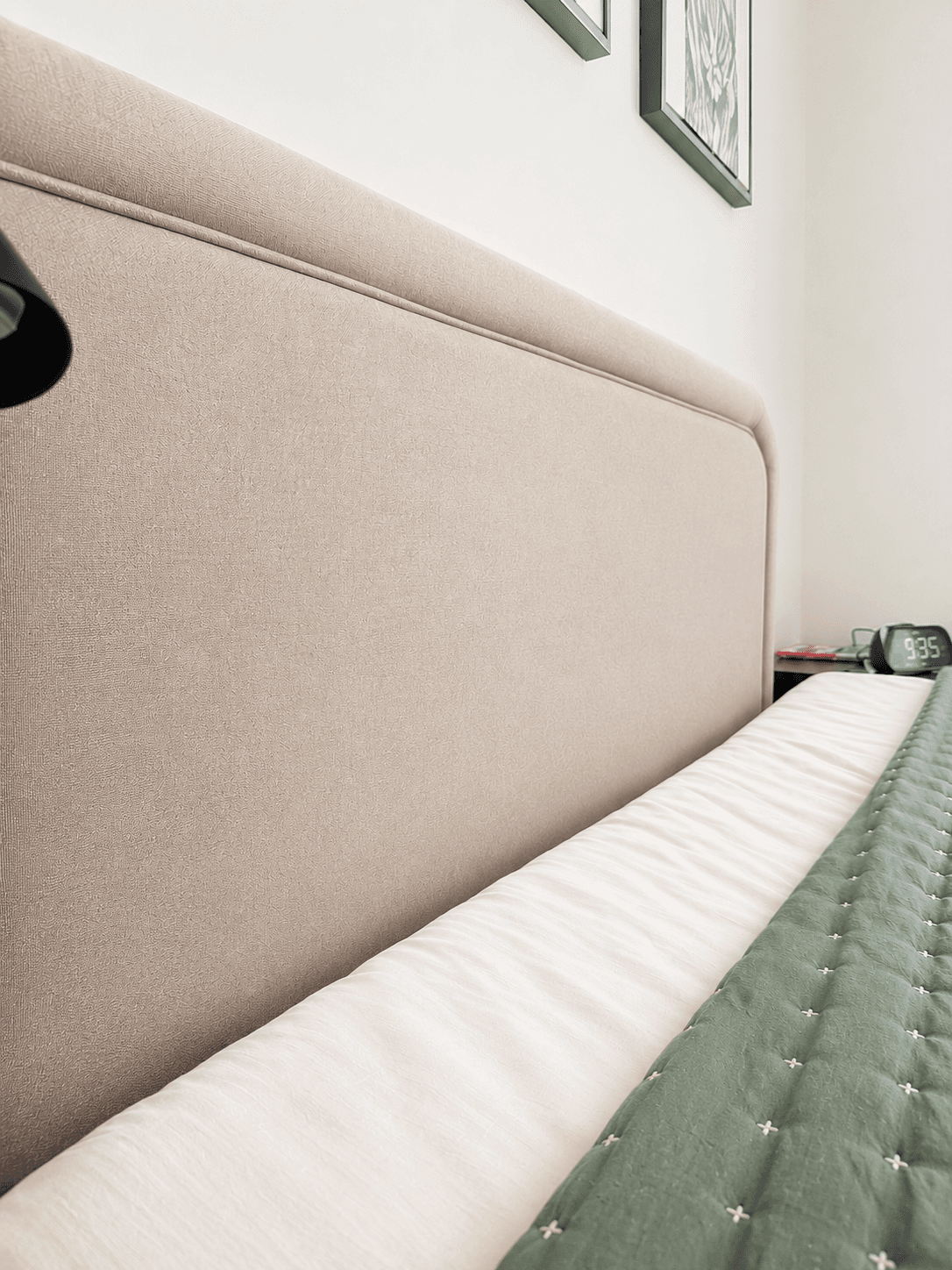 Bed made with fresh linens and a neatly finished headboard after a ShinySpaces cleaning