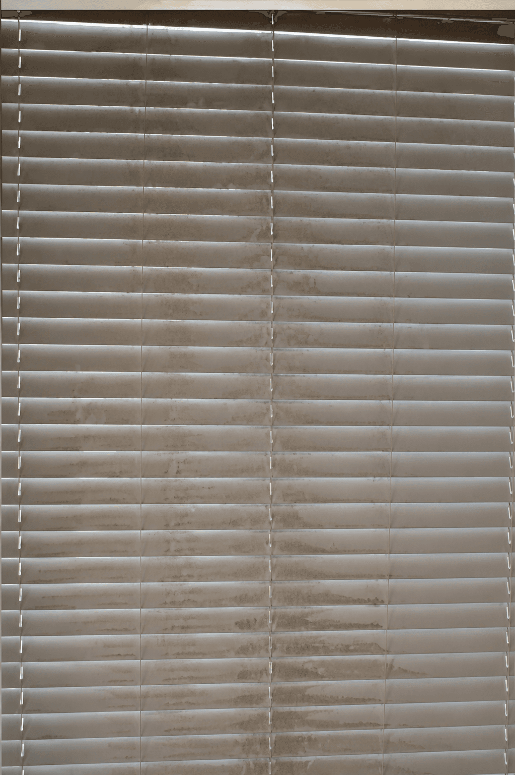 Window blinds coated in dust and grime before a ShinySpaces cleaning