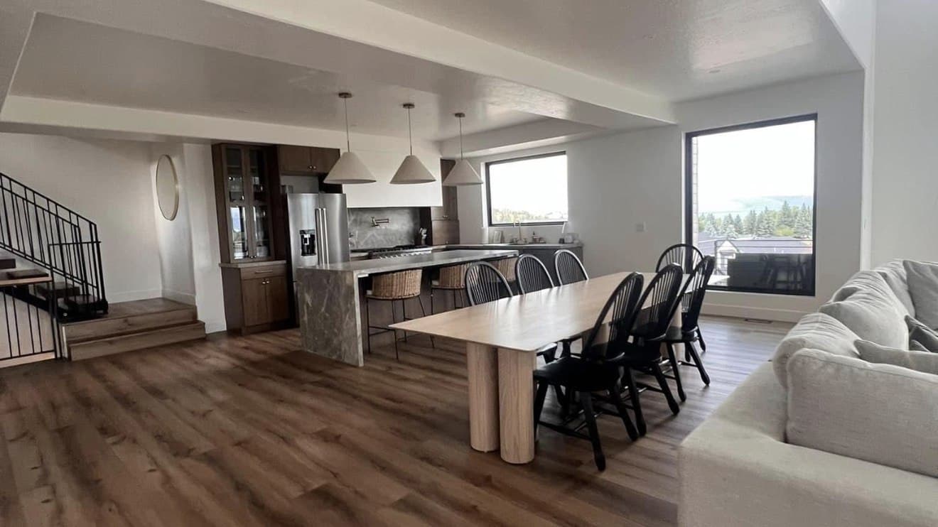 Bright open-concept living, dining, and kitchen area with mountain views, ready for the next guest after a ShinySpaces Airbnb turnover cleaning